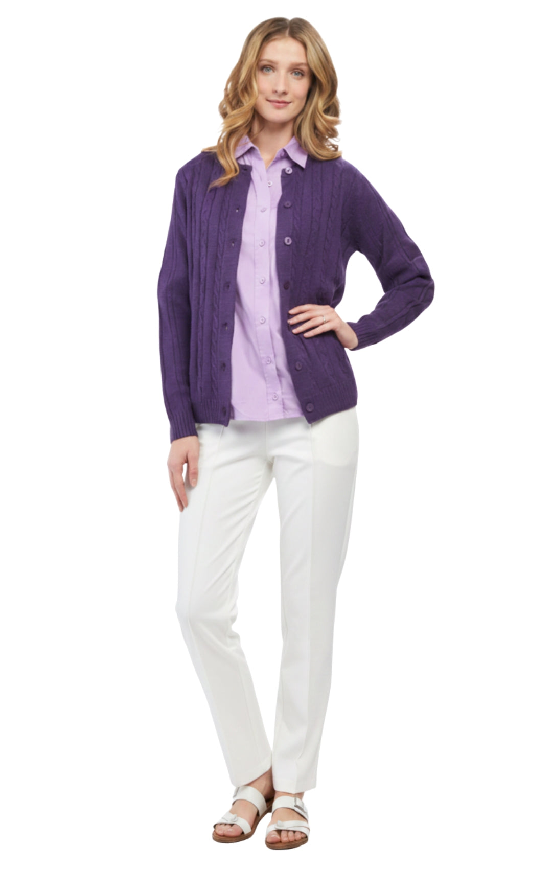 Woman wearing a purple cardigan over a light purple shirt with white pants on a white background