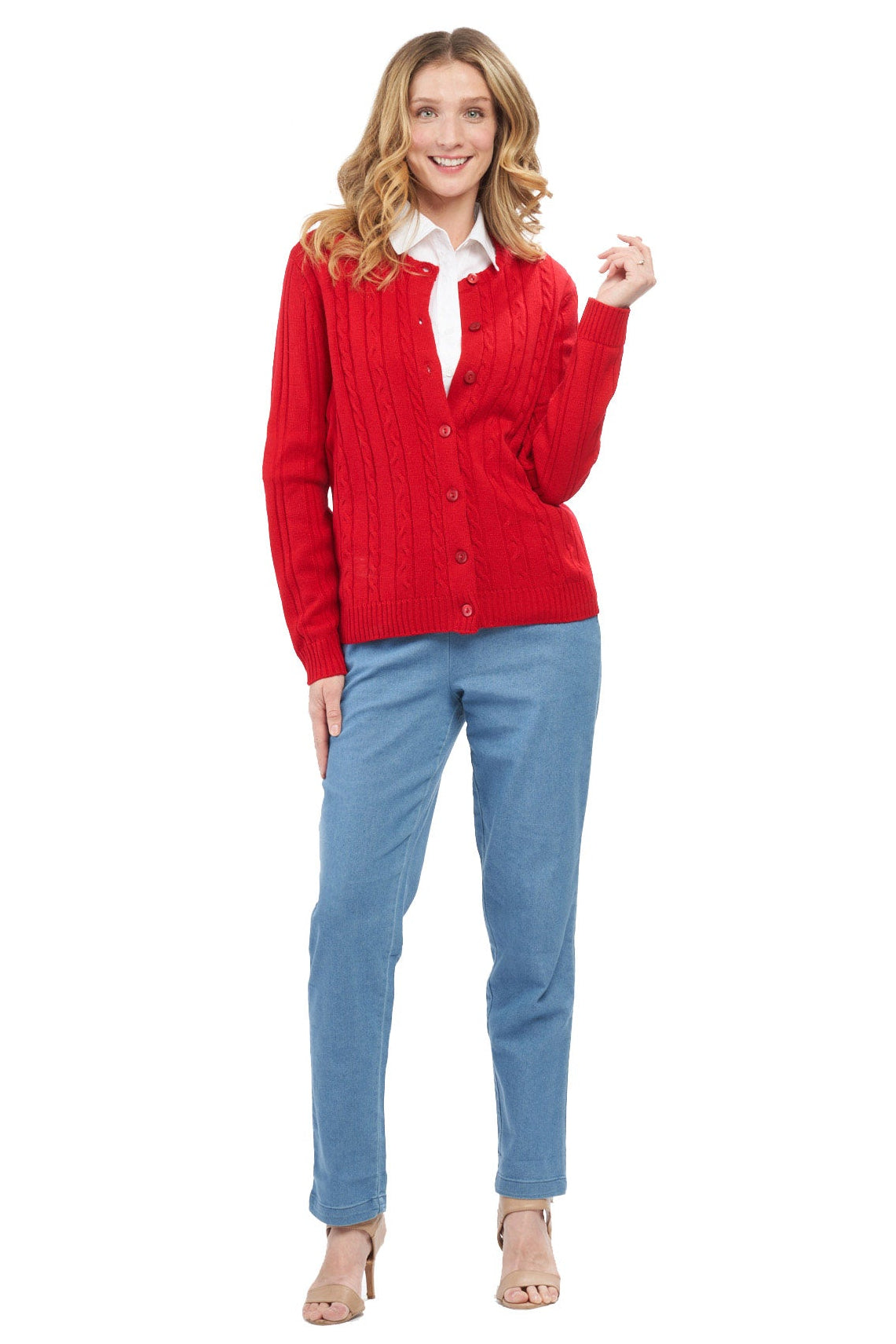 Woman wearing a red cardigan and blue pants on a white background