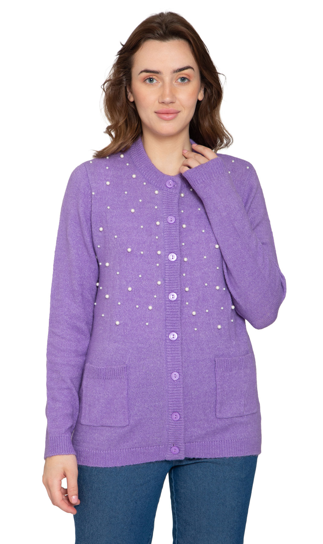A woman wearing a purple cardigan with faux pearl accents on the front and pearl buttons. The cardigan has a crew neck and two front patch pockets.